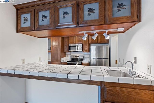 a kitchen with a sink cabinets and window