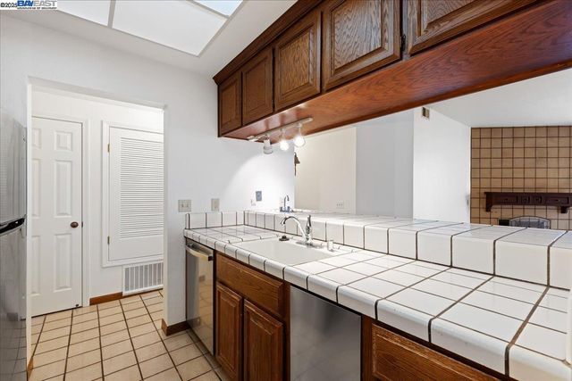 a kitchen with a sink cabinets and window