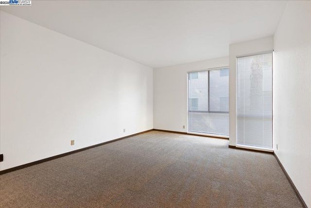 a view of an empty room and chandelier