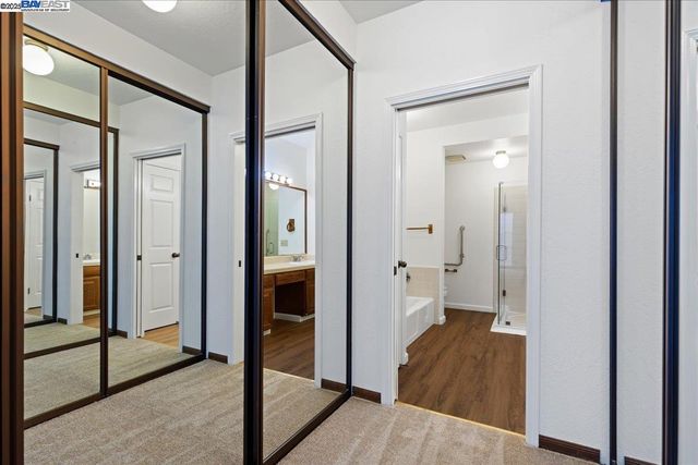 a view of a bathroom with tub shower bedroom and wooden floor