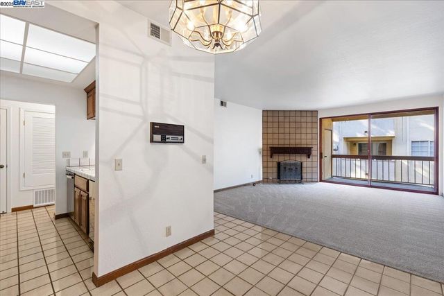 a view of a livingroom with an empty space and a fireplace