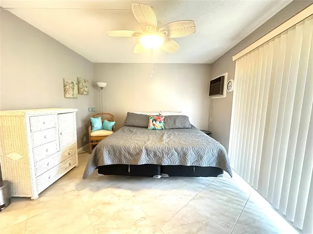 a bedroom with two beds and a chandelier