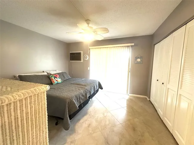 an empty room with closet and windows