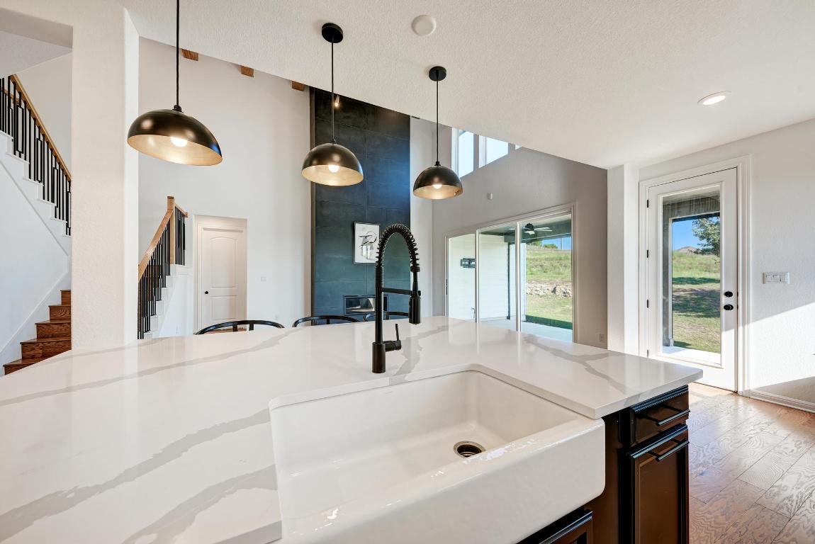 156 Verdejo Drive Dripping Springs, TX 78620 - Photo 17 of 38 a bathroom with a sink a large mirror and a large window