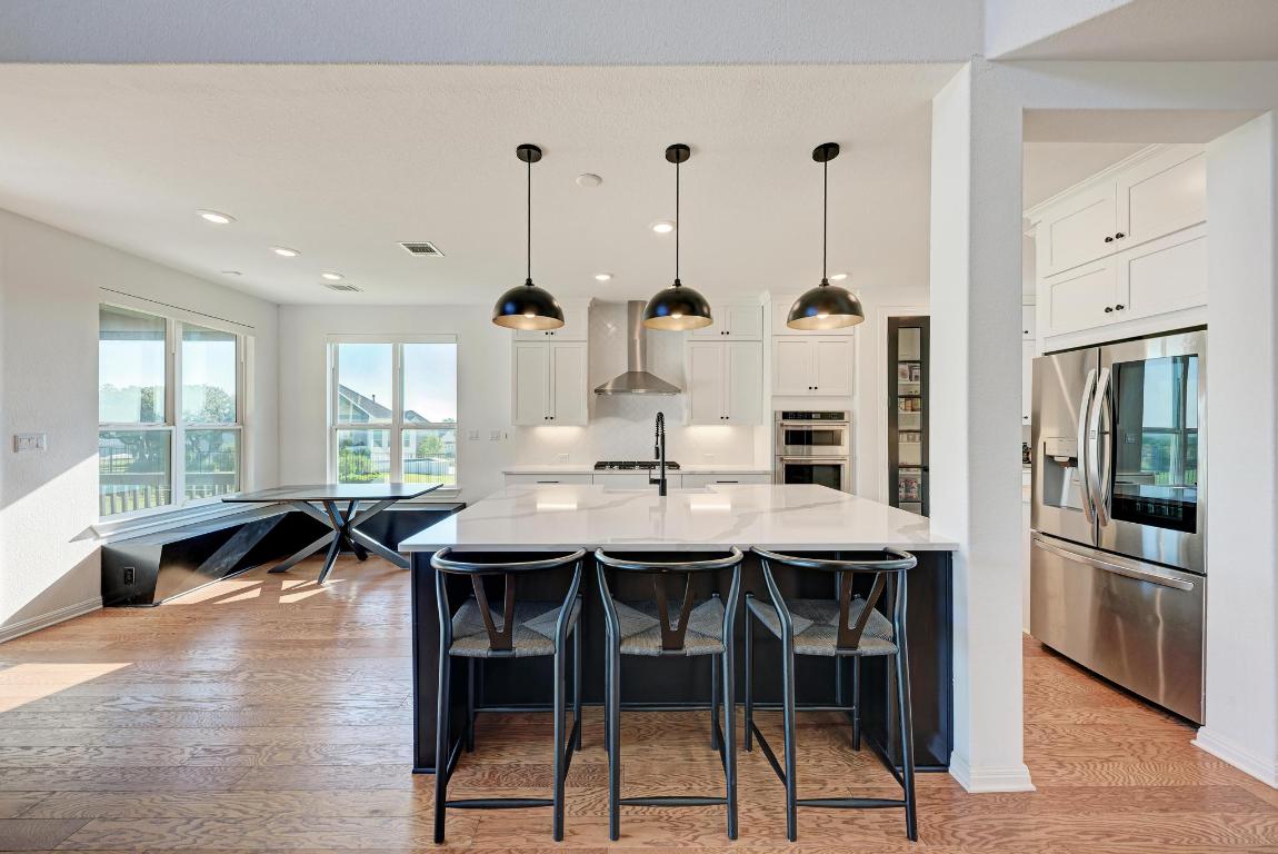 156 Verdejo Drive Dripping Springs, TX 78620 - Photo 3 of 38 a dinning area with furniture and wooden floor