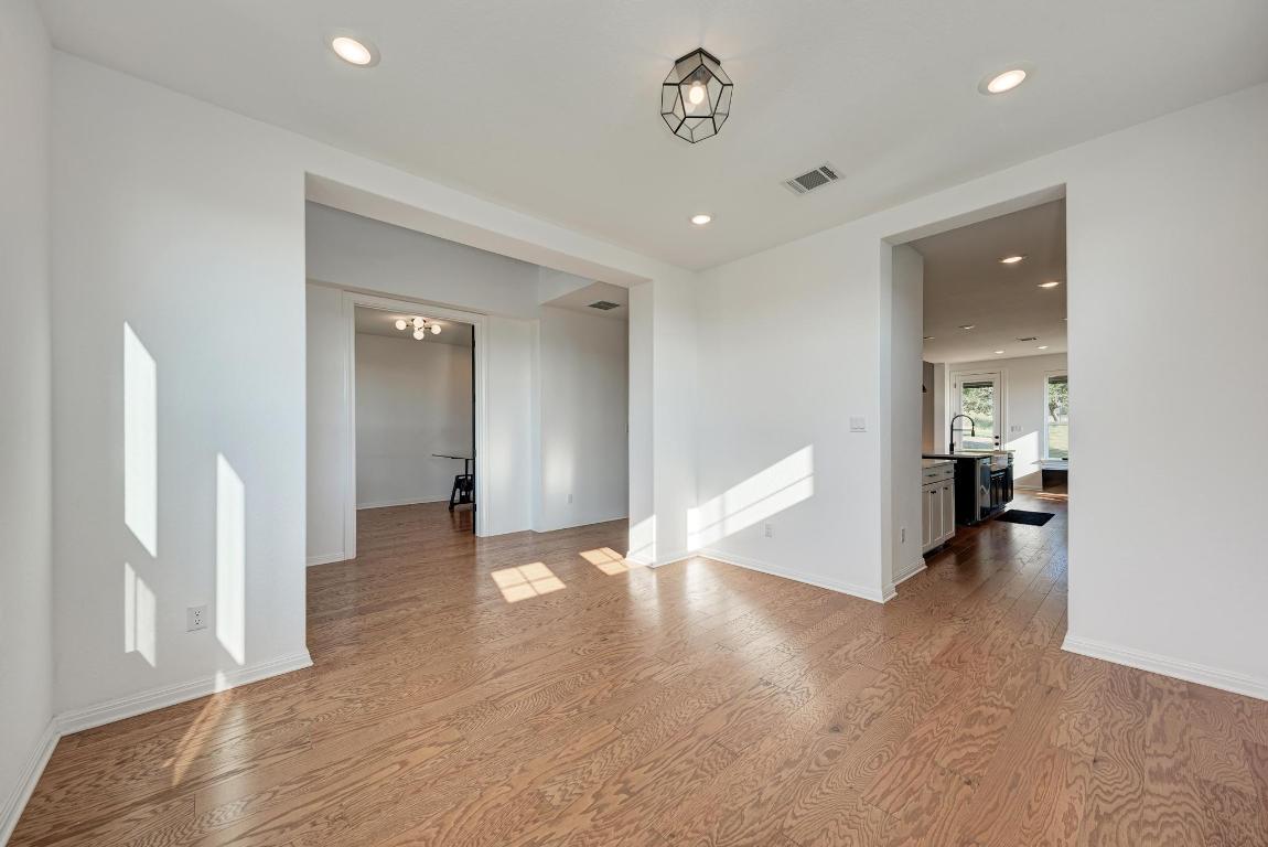 156 Verdejo Drive Dripping Springs, TX 78620 - Photo 7 of 38 an empty room with wooden floor and windows
