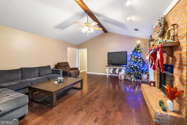 a living room with furniture and a flat screen tv