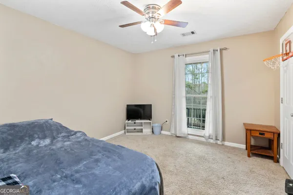 a bedroom with a bed and a tv on the dresser