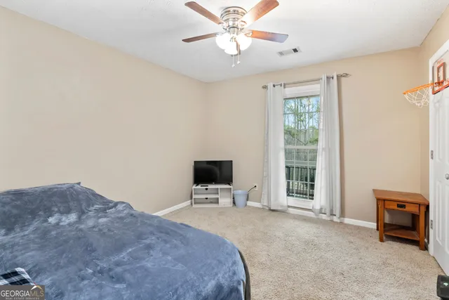 a bedroom with a bed and a tv on the dresser
