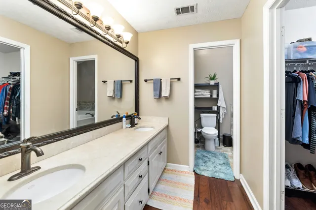 a spacious bathroom with a double vanity sink and a mirror