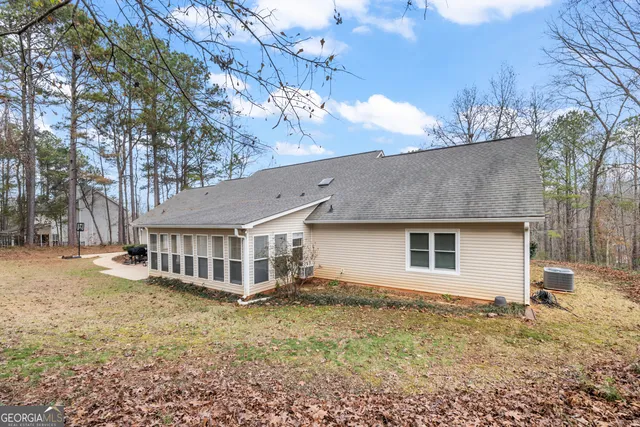 a view of a house with a yard covered in snow