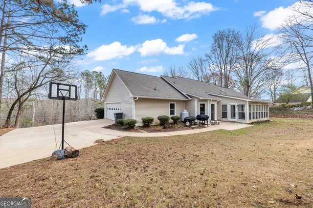 a front view of a house with a yard and lake view