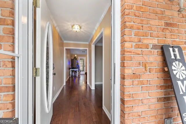 a view of hallway with wooden floor and stairs