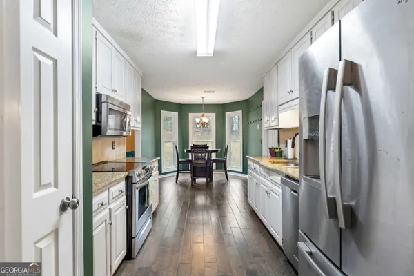 a kitchen with stainless steel appliances a refrigerator and a stove top oven