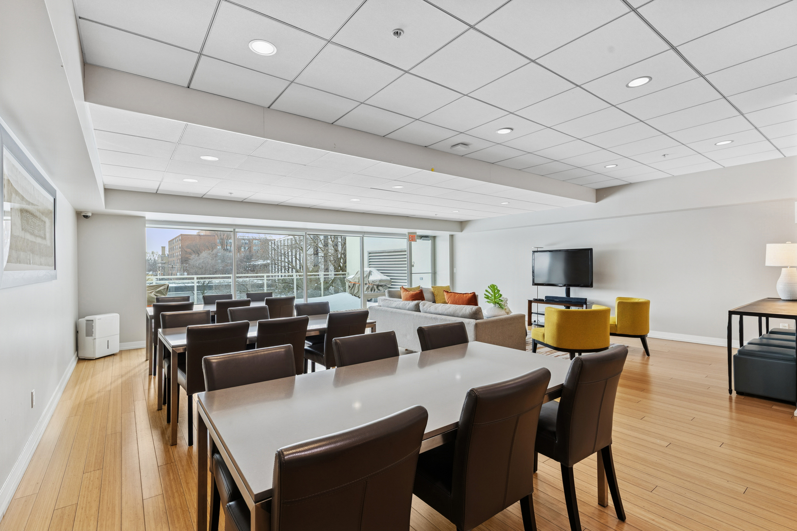 1570 Elmwood Avenue, Unit 1504 Evanston, IL 60201 - Photo 22 of 24 a living room with furniture a large window and a wooden floor