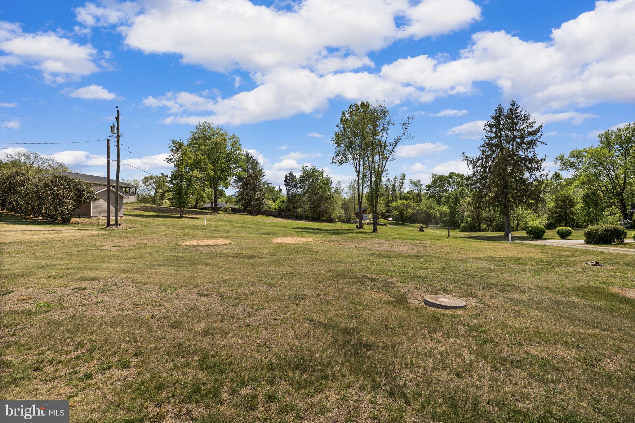 12157 Octonia Road Orange, VA 22960 - Photo 37 of 45 Spacious green landscape under blue skies.
