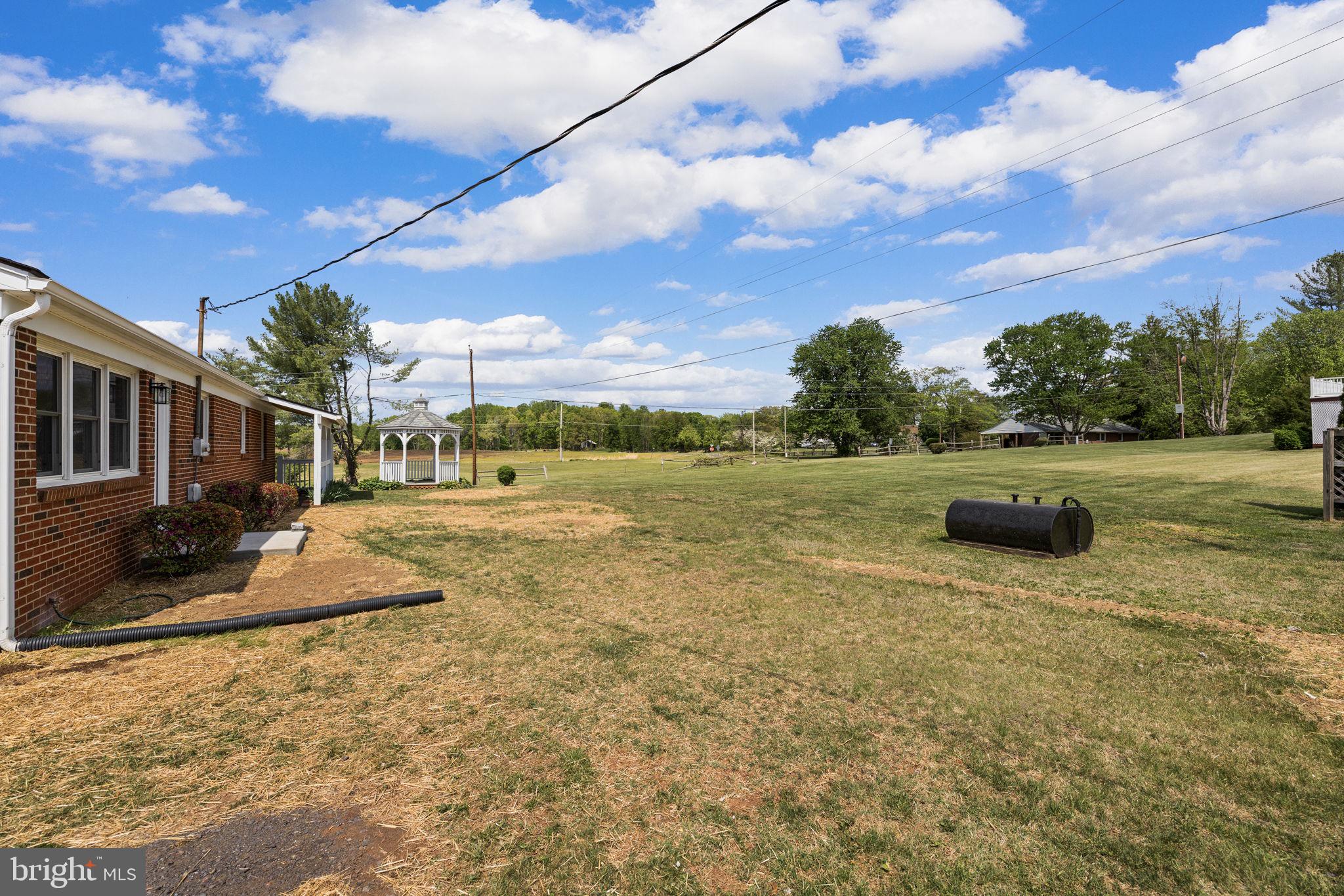 12157 Octonia Road Orange, VA 22960 - Photo 38 of 45 Spacious yard under a bright sky.