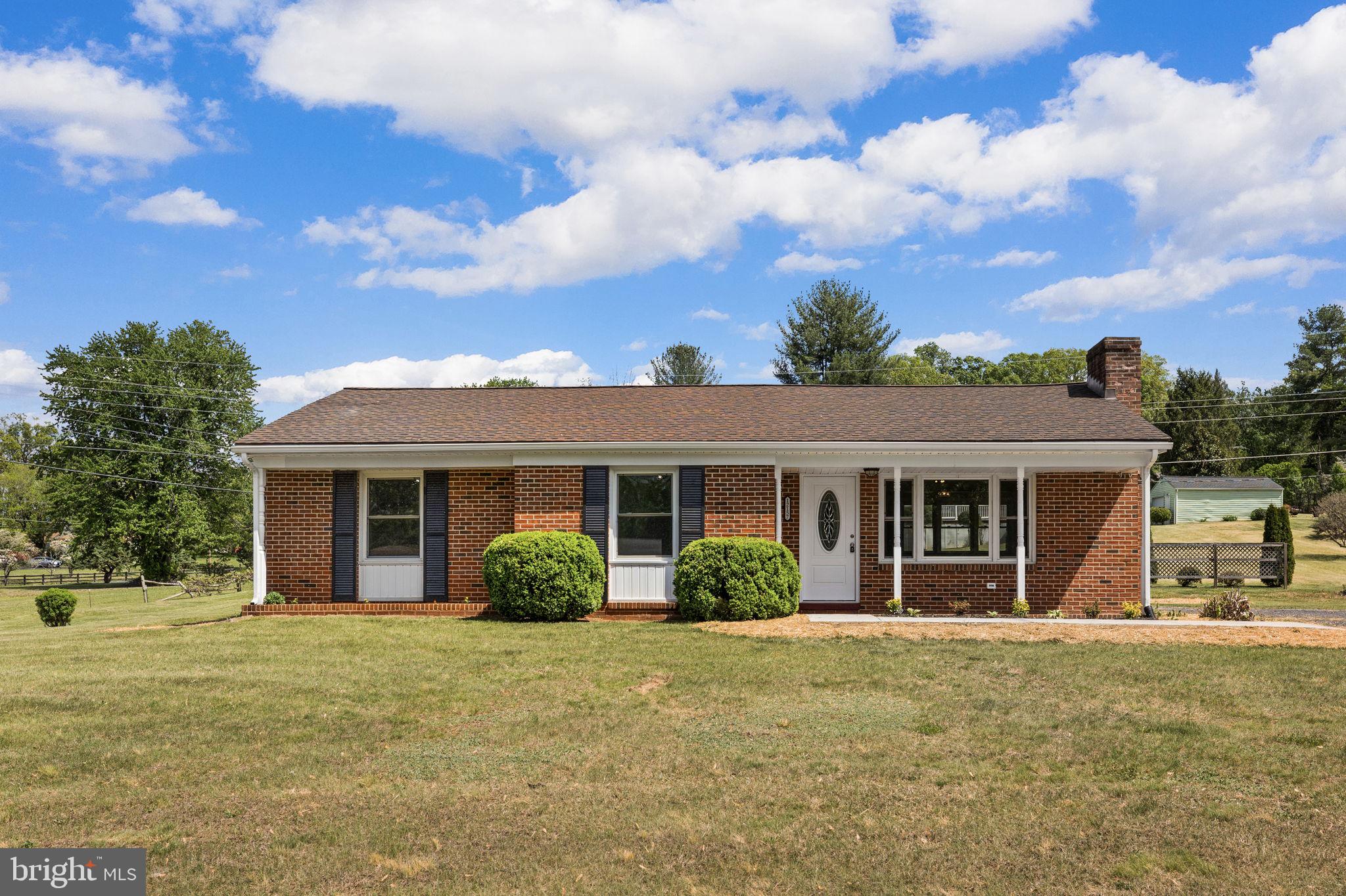 12157 Octonia Road Orange, VA 22960 - Photo 4 of 45 Charming brick home with lush greenery.