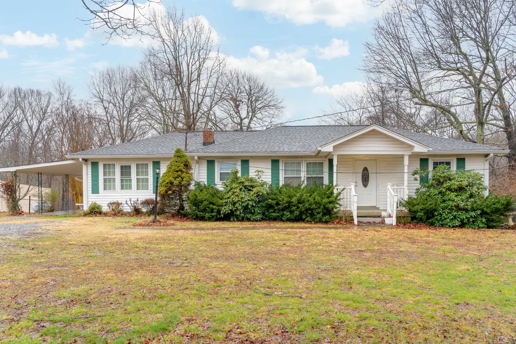 a front view of house with yard and green space