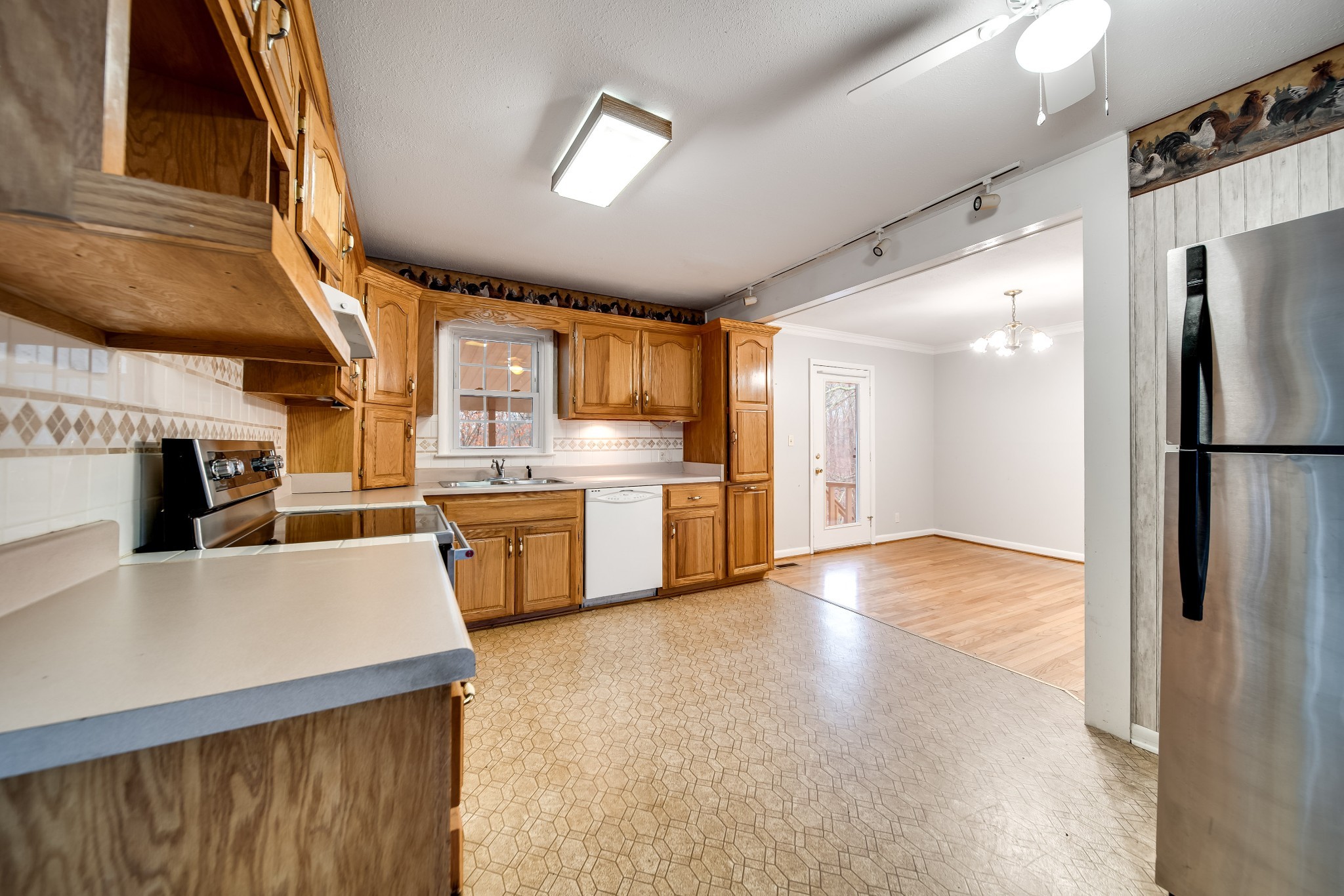 5945 Dividing Ridge Road Goodlettsville, TN 37072 - Photo 23 of 46 a view of a kitchen with a sink a refrigerator and cabinets
