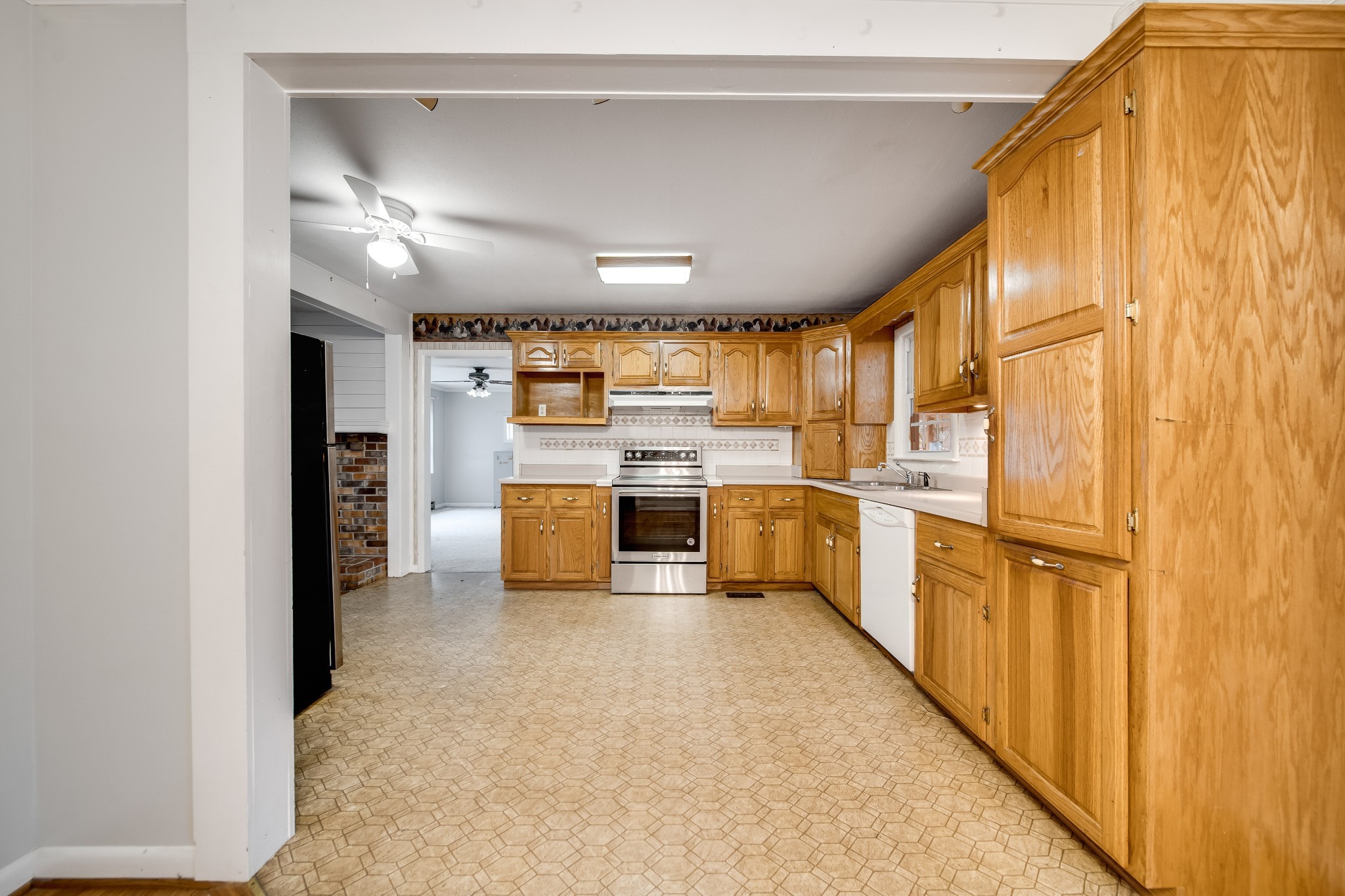 5945 Dividing Ridge Road Goodlettsville, TN 37072 - Photo 25 of 46 a kitchen with refrigerator cabinets and large window