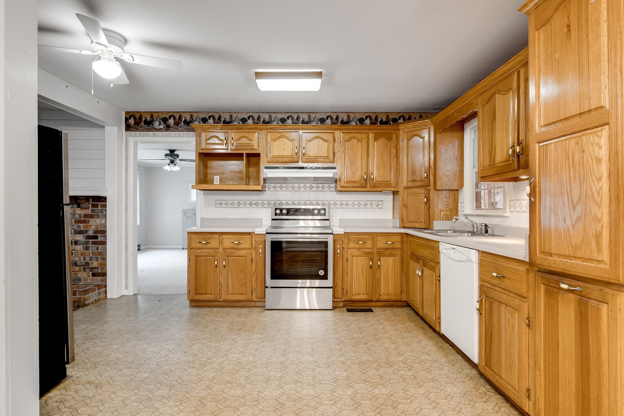 5945 Dividing Ridge Road Goodlettsville, TN 37072 - Photo 26 of 46 a kitchen with stainless steel appliances granite countertop a stove a sink and a refrigerator