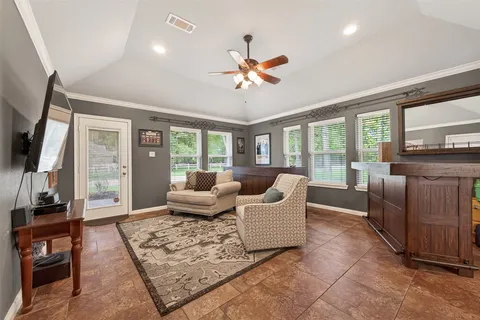a living room with fireplace furniture and a flat screen tv