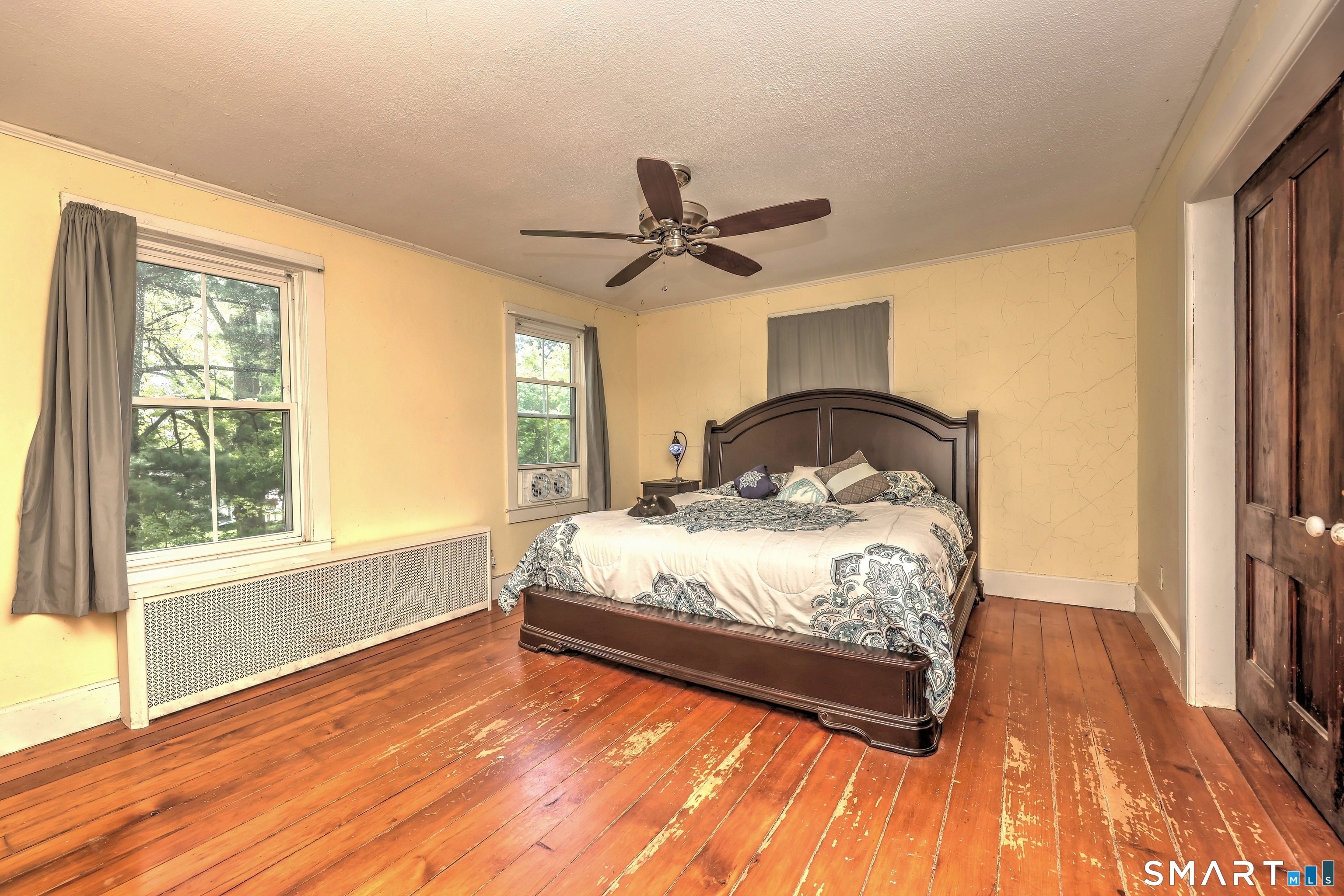 186 Jones Hill Road West Haven, CT 06516 - Photo 21 of 33 a bedroom with a bed and a chandelier