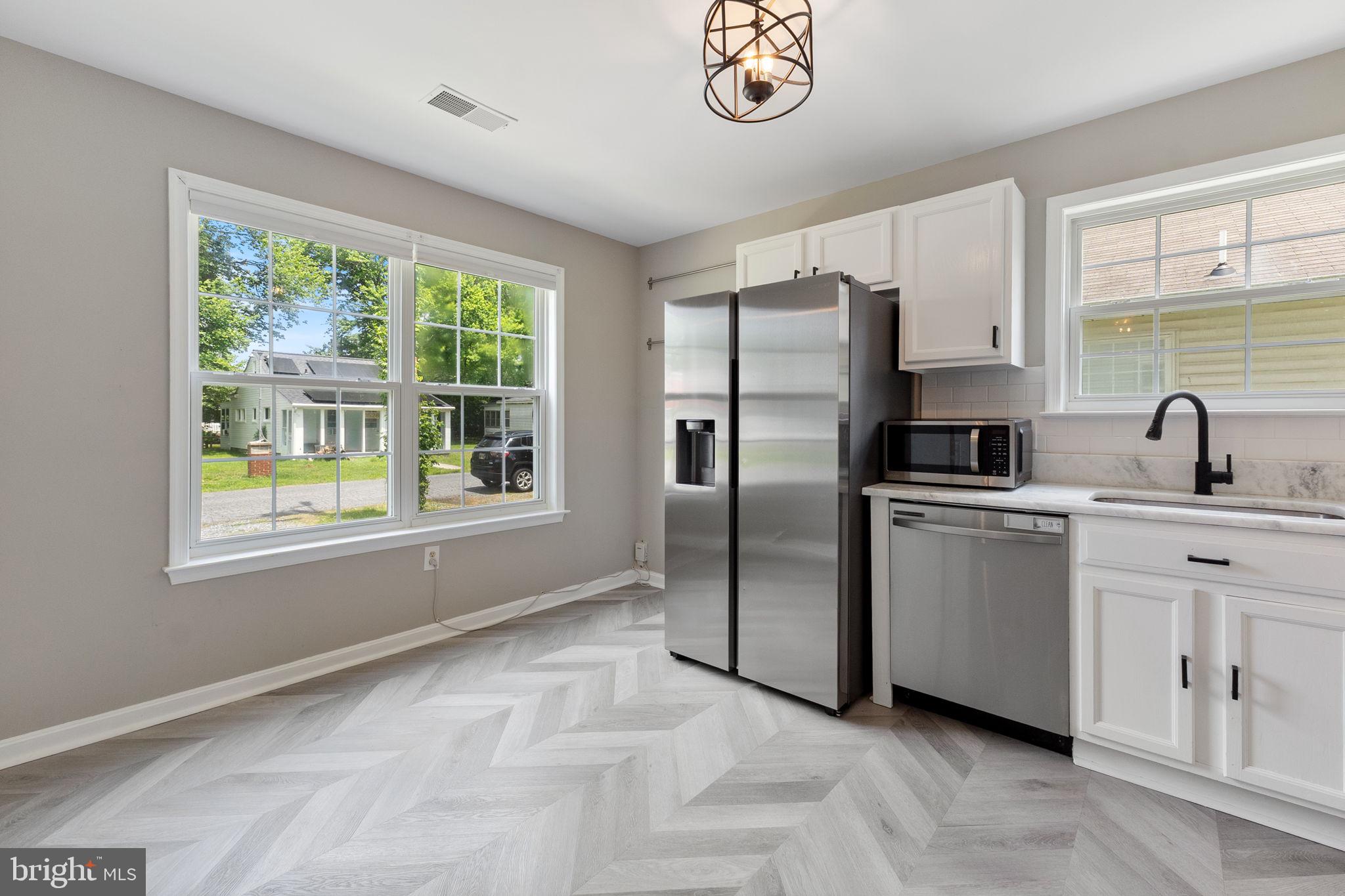 1527 Lincoln Road Shady Side, MD 20764 - Photo 5 of 30 a kitchen with stainless steel appliances a refrigerator sink and window