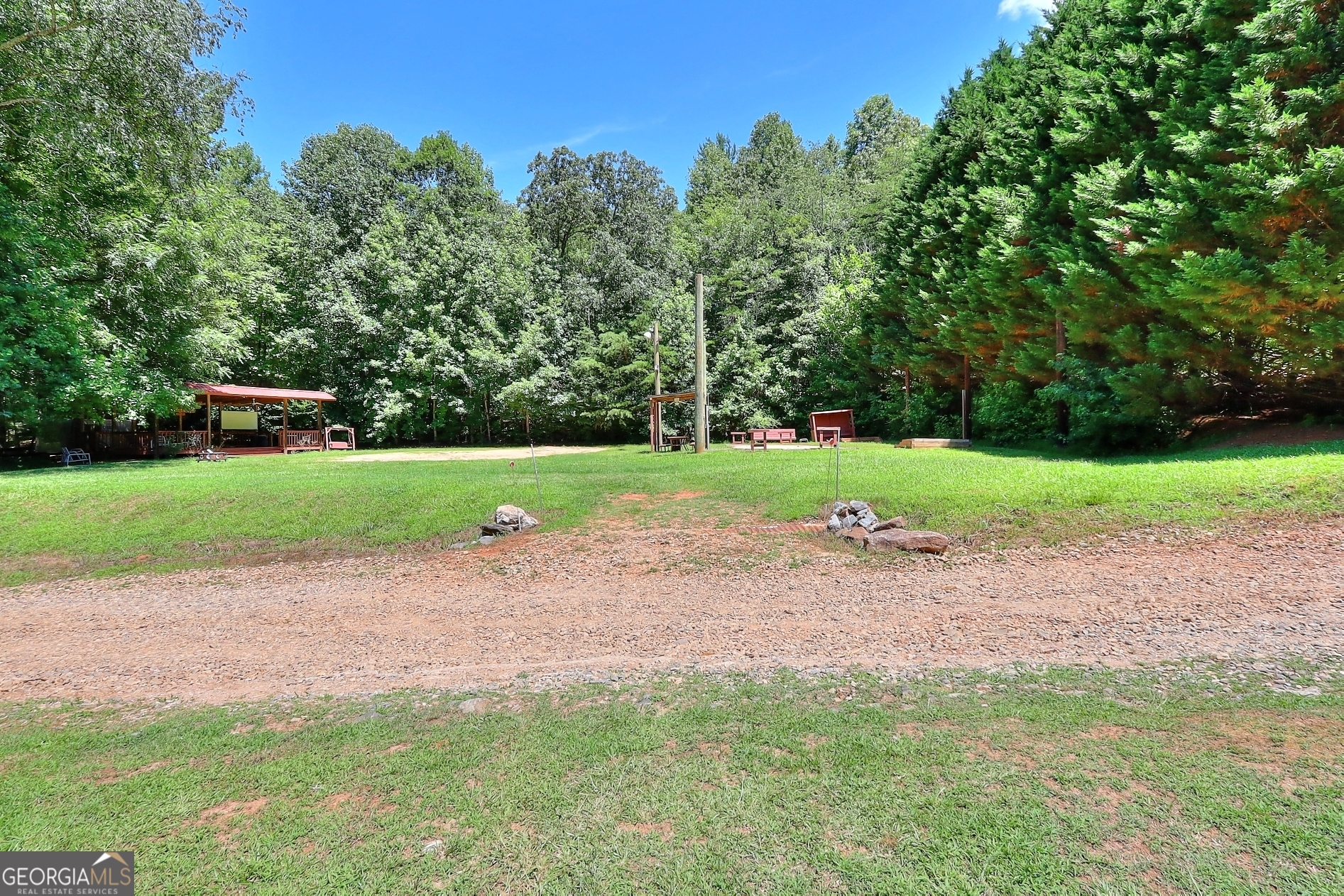 95 Cedar Hollow Road Cleveland, GA 30528 - Photo 53 of 54 a backyard of a house with lots of green space and trees