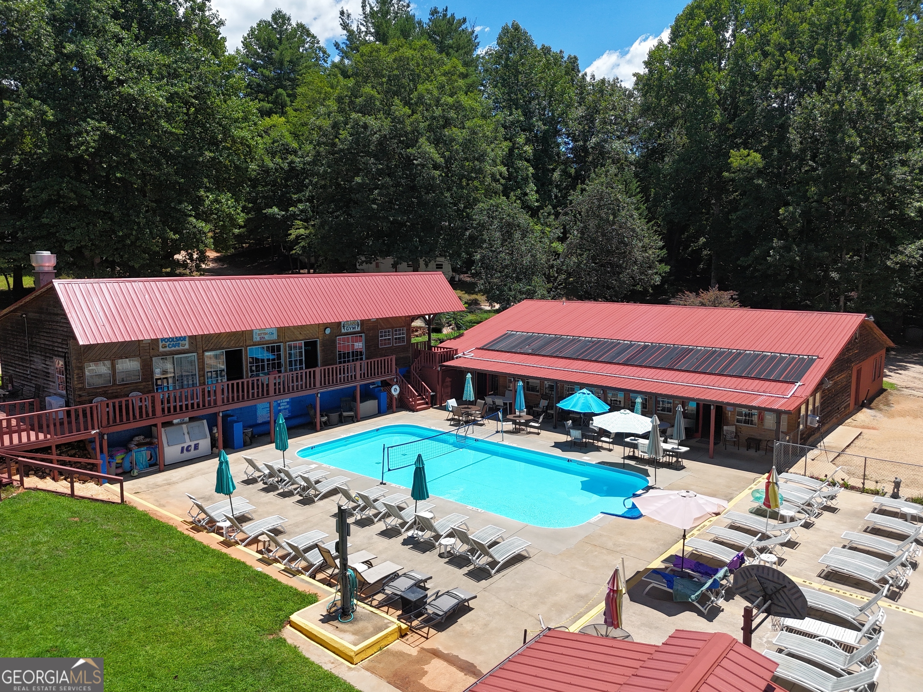 95 Cedar Hollow Road Cleveland, GA 30528 - Photo 6 of 54 a view of a swimming pool with lawn chairs under an umbrella