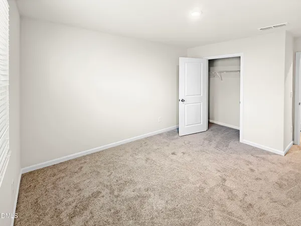 an empty room with closet area