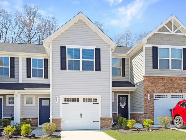 a front view of a house with a yard and garage