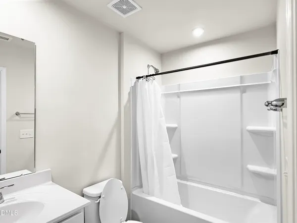 a bathroom with a sink mirror vanity and toilet