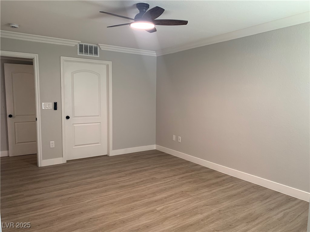 8101 West Flamingo Road, Unit 1102 Las Vegas, NV 89147 - Photo 37 of 54 Bedroom with ceiling fan, light wood-style flooring, a smoke detector, and ornamental molding