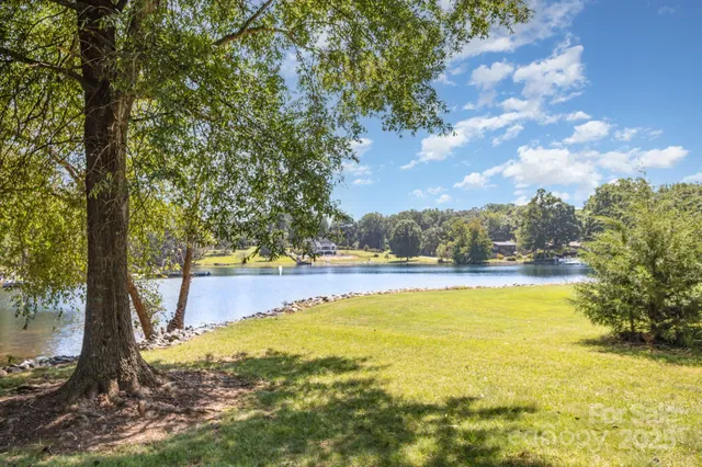 a lake view with boat and trees