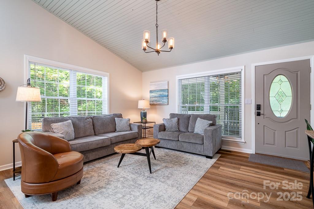 8410 Slate Street Terrell, NC 28682 - Photo 11 of 38 a living room with furniture a chandelier and a large window