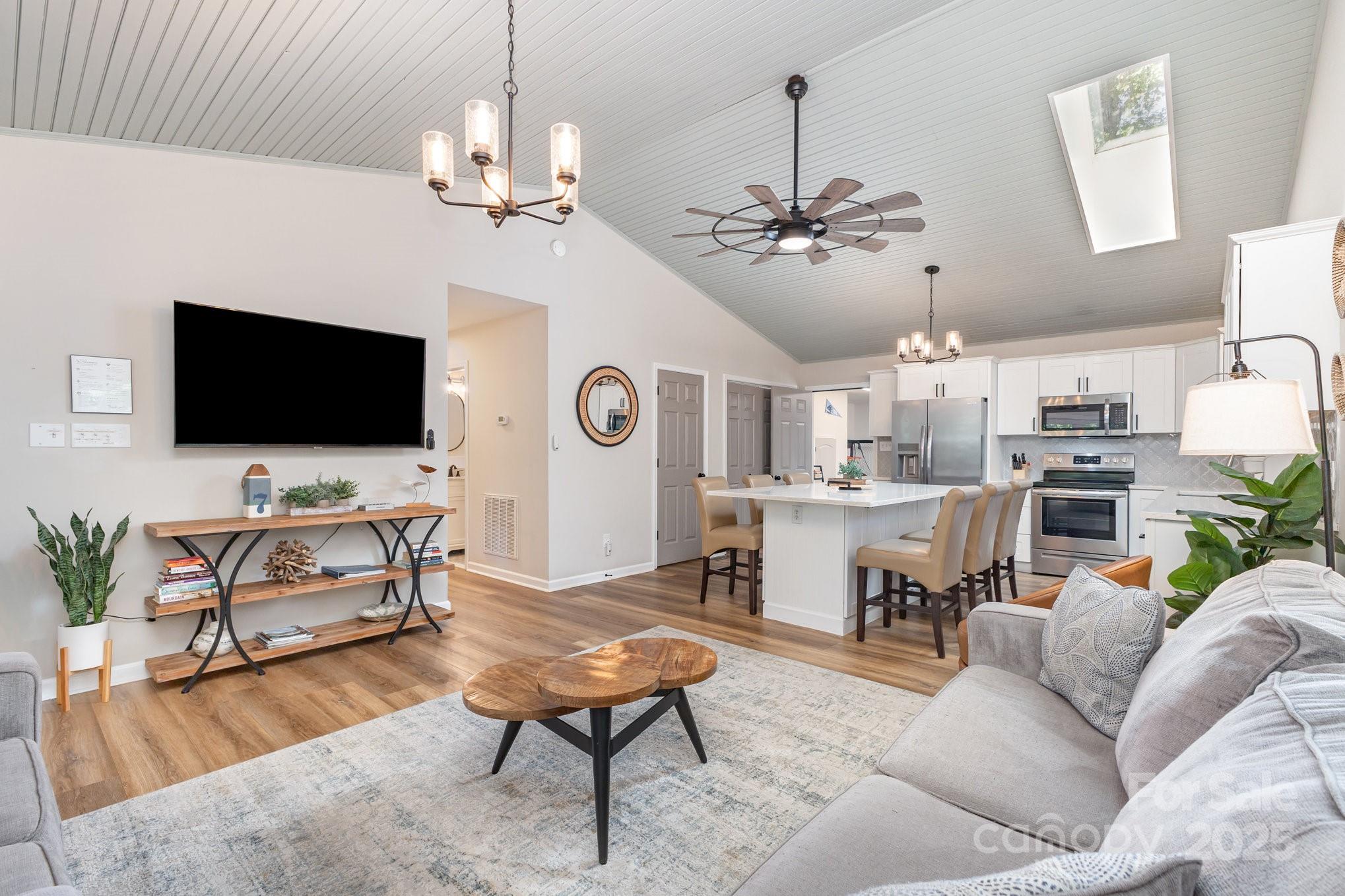 8410 Slate Street Terrell, NC 28682 - Photo 12 of 38 a living room with furniture a chandelier and a flat screen tv