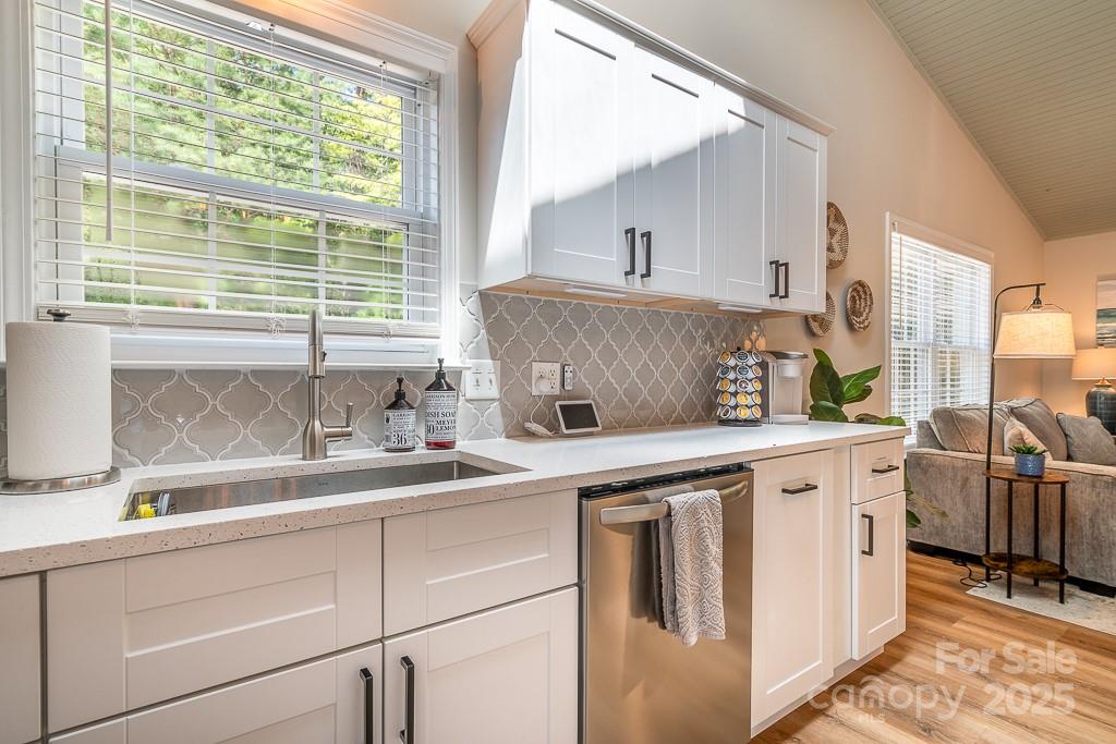 8410 Slate Street Terrell, NC 28682 - Photo 16 of 38 a kitchen with white cabinets and white appliances