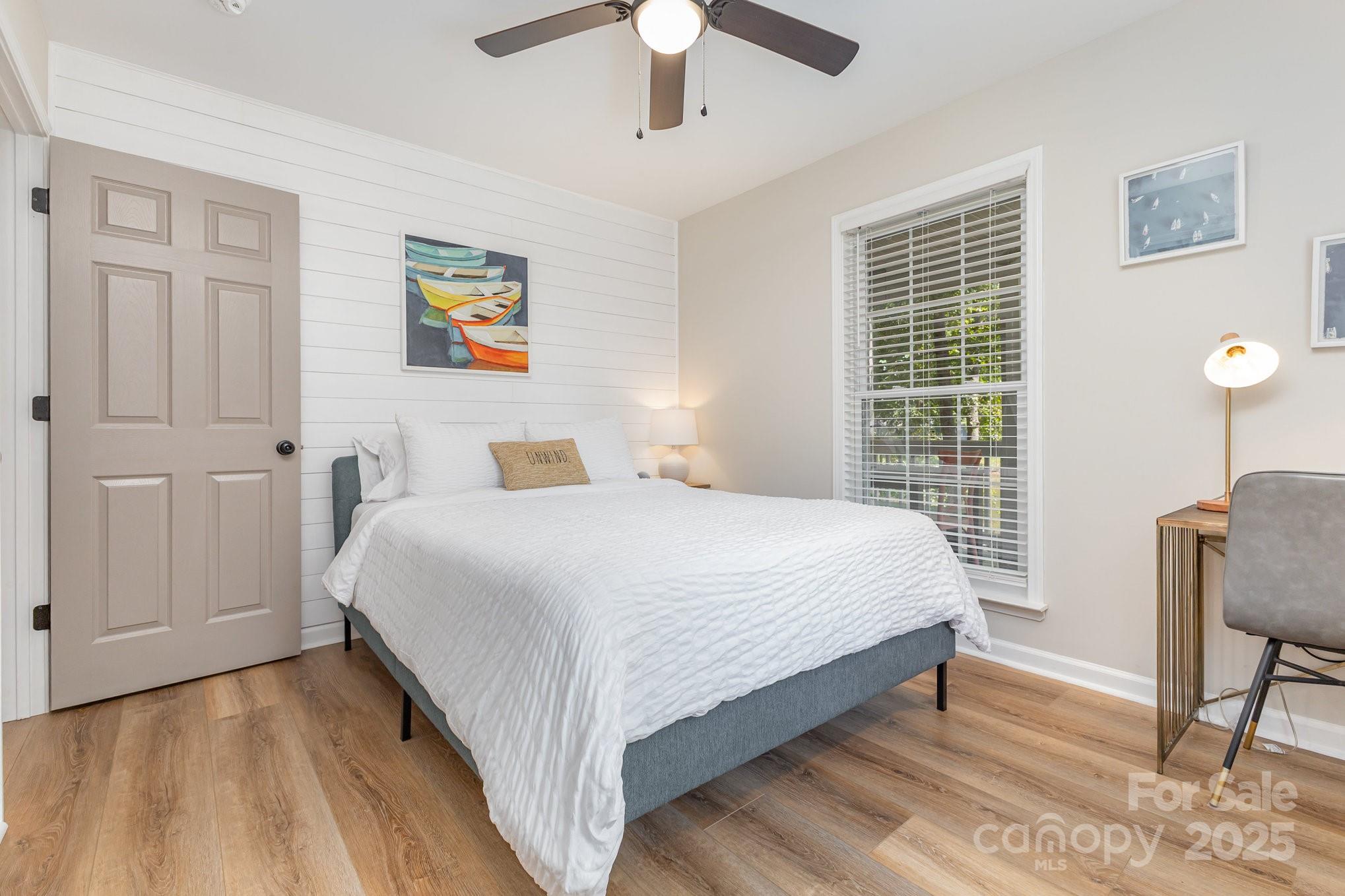 8410 Slate Street Terrell, NC 28682 - Photo 21 of 38 a bedroom with a large bed and a chandelier