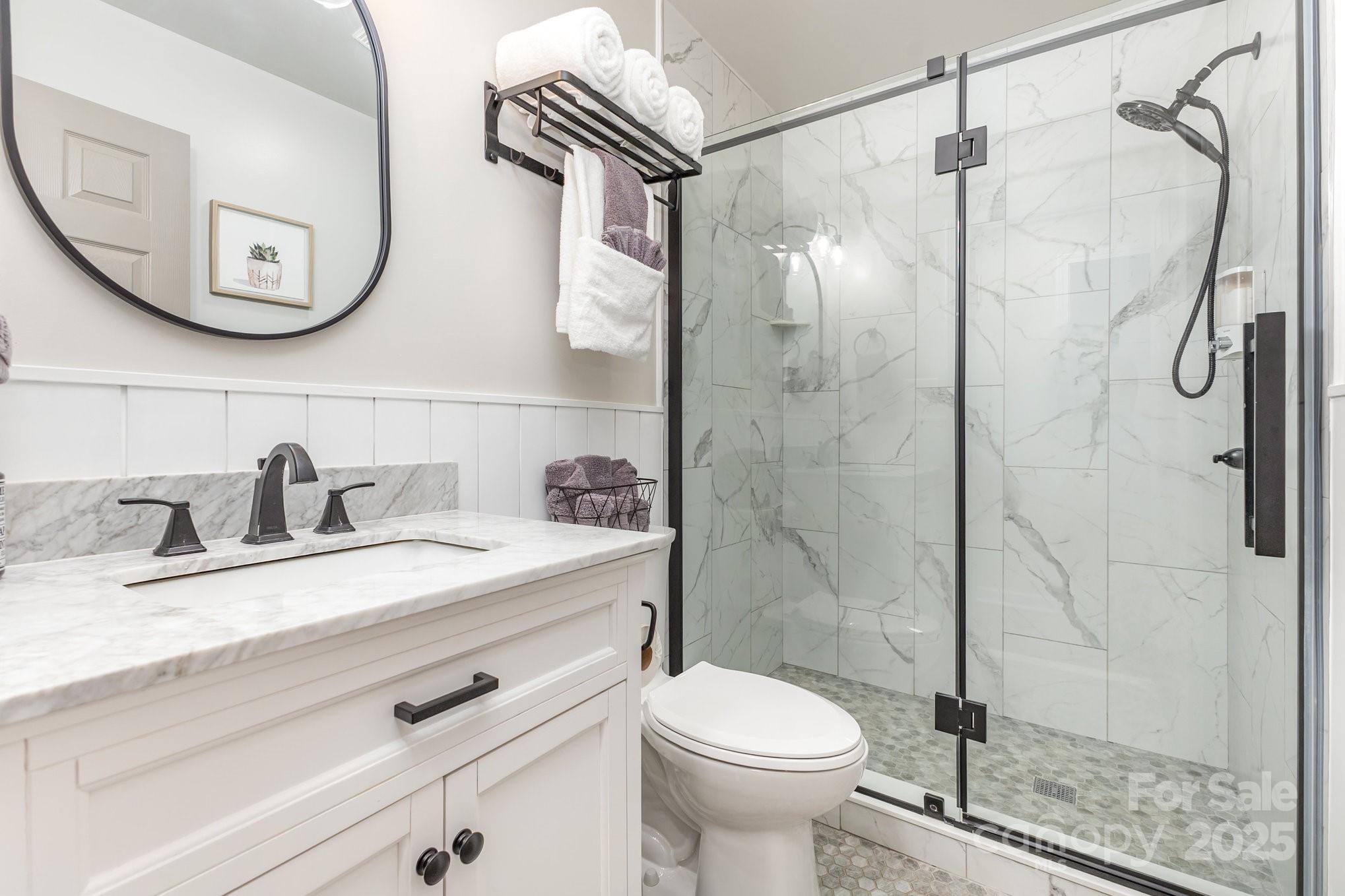 8410 Slate Street Terrell, NC 28682 - Photo 22 of 38 a bathroom with a granite countertop sink toilet and shower