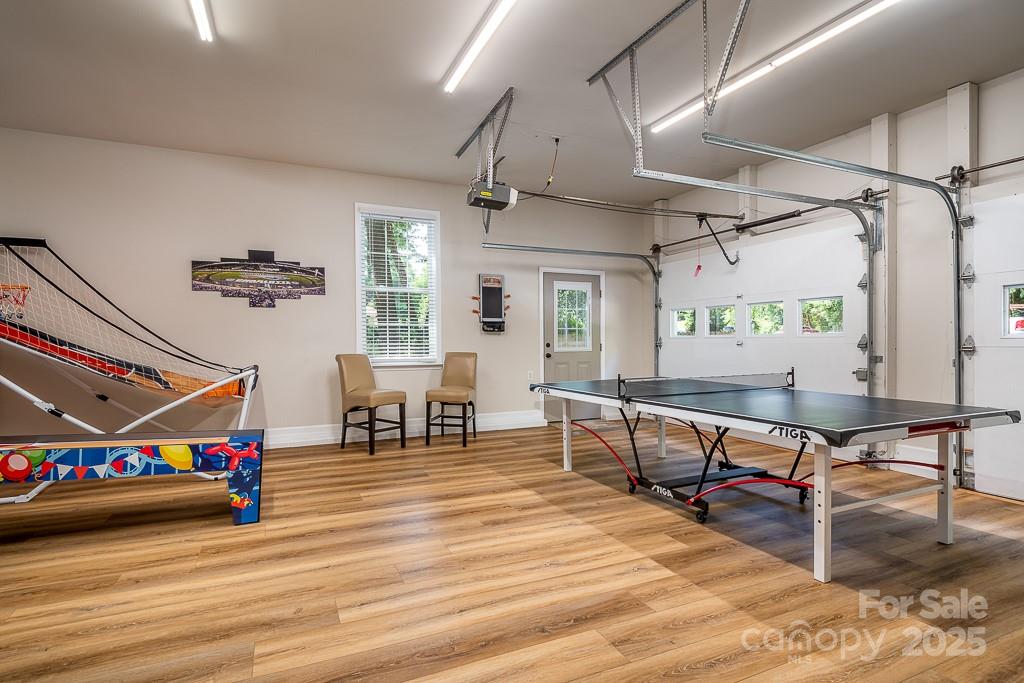 8410 Slate Street Terrell, NC 28682 - Photo 24 of 38 a living room with furniture a pool table and a wooden floor