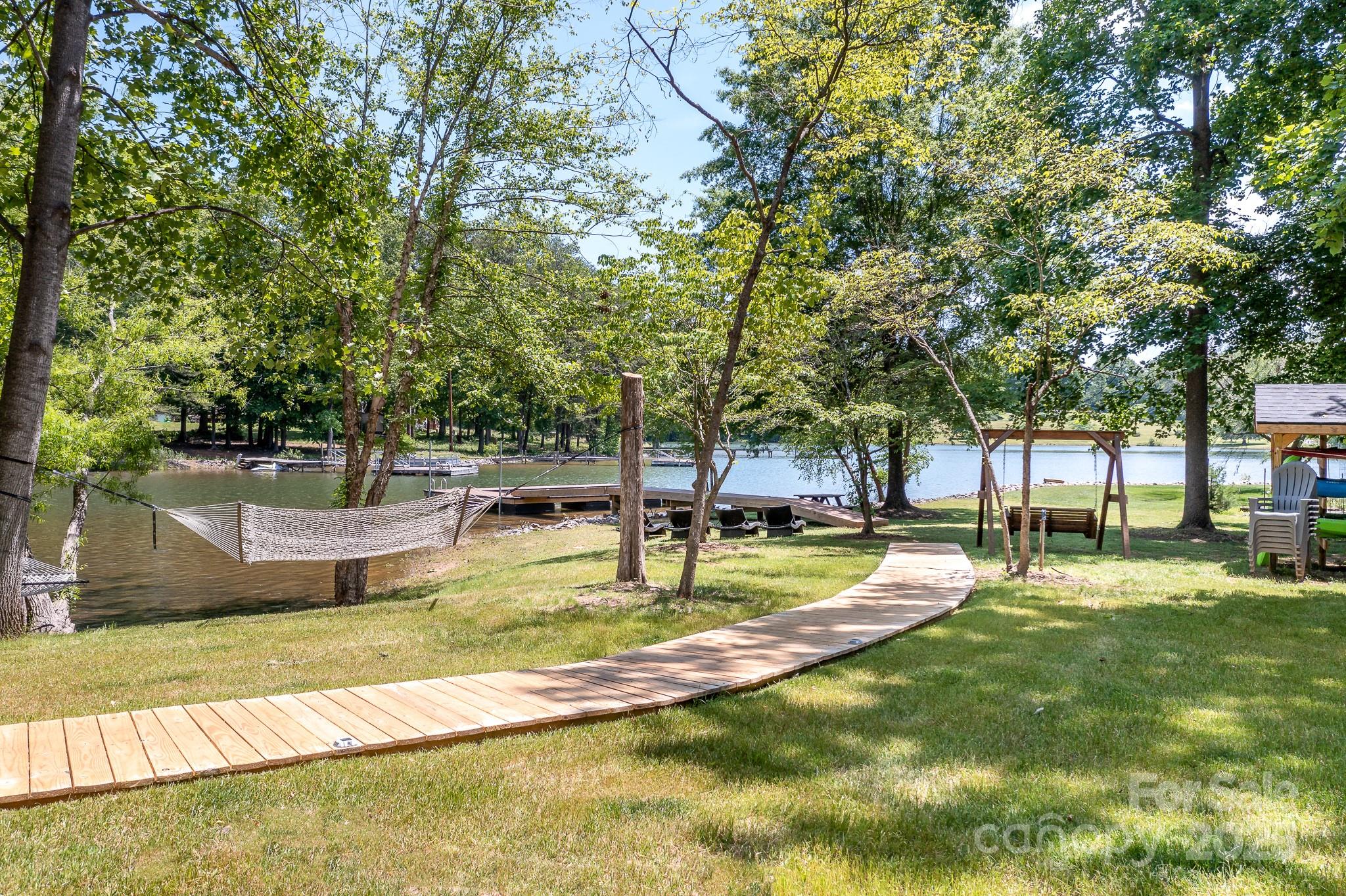 8410 Slate Street Terrell, NC 28682 - Photo 28 of 38 a view of swimming pool with lawn chairs and plants