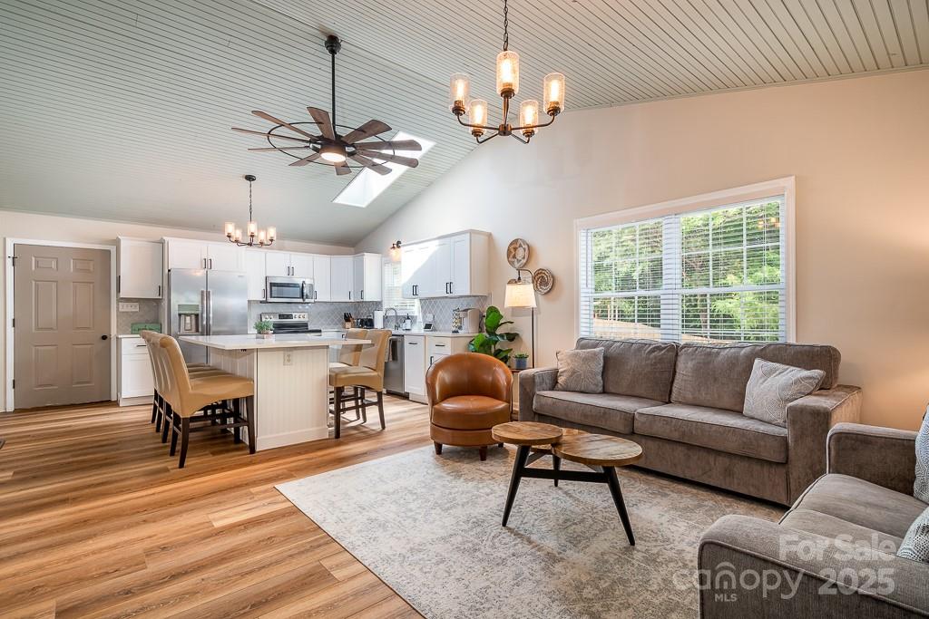 8410 Slate Street Terrell, NC 28682 - Photo 10 of 38 a living room with furniture a chandelier and a dining table