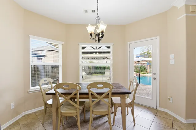 a view of a dining room with furniture and windows