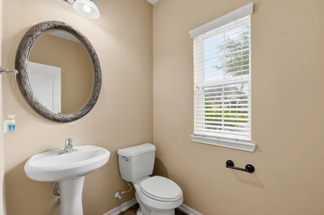 a bathroom with a sink a toilet and a mirror