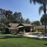 a front view of house with yard and outdoor seating