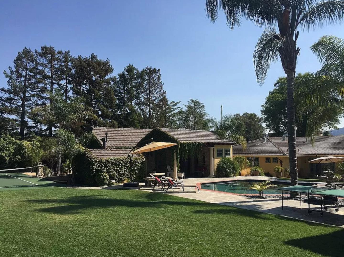 a front view of house with yard and outdoor seating