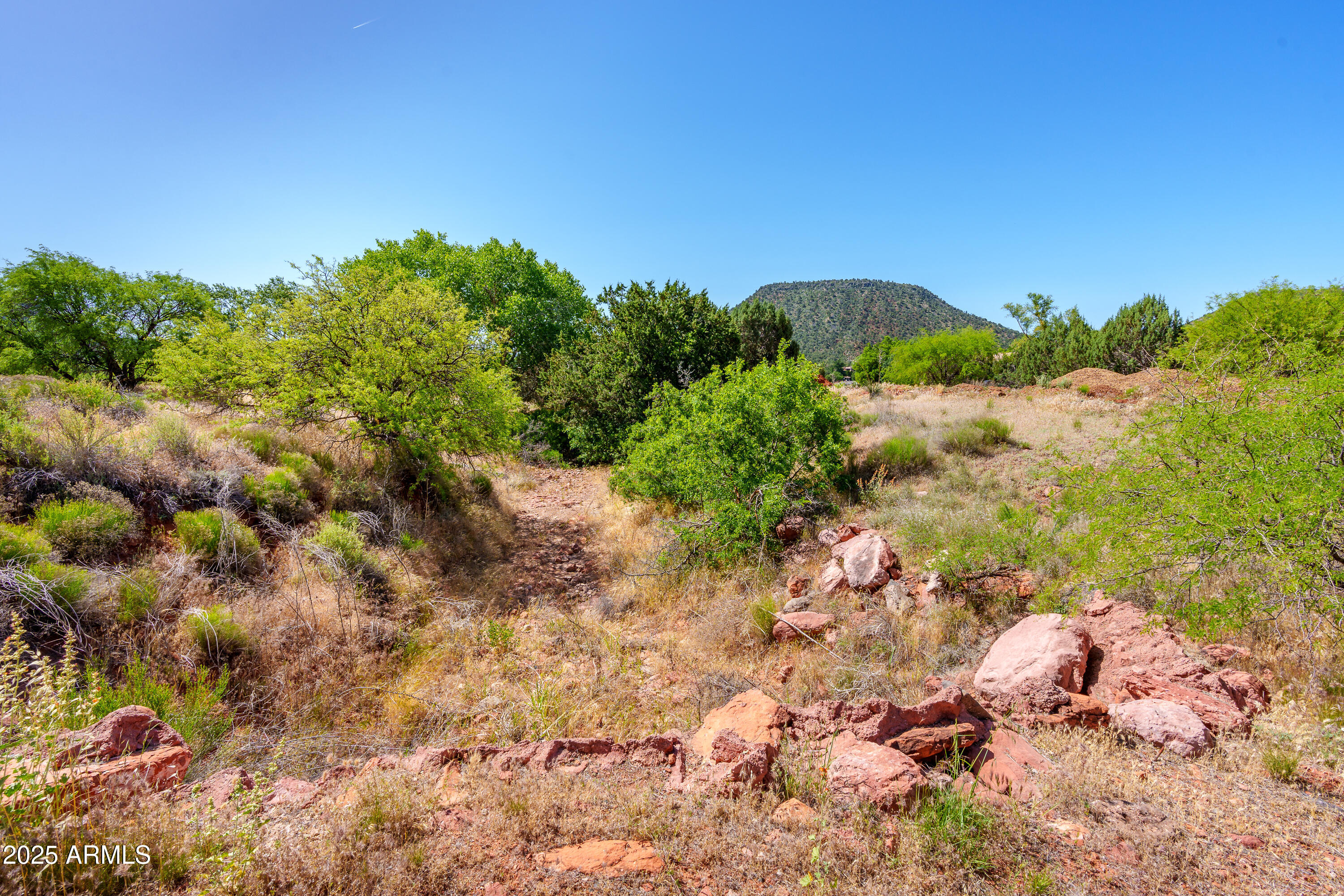 105 East Saddlehorn Road, Unit 161 Sedona, AZ 86351 - Photo 23 of 33 a view of a lake with a tree