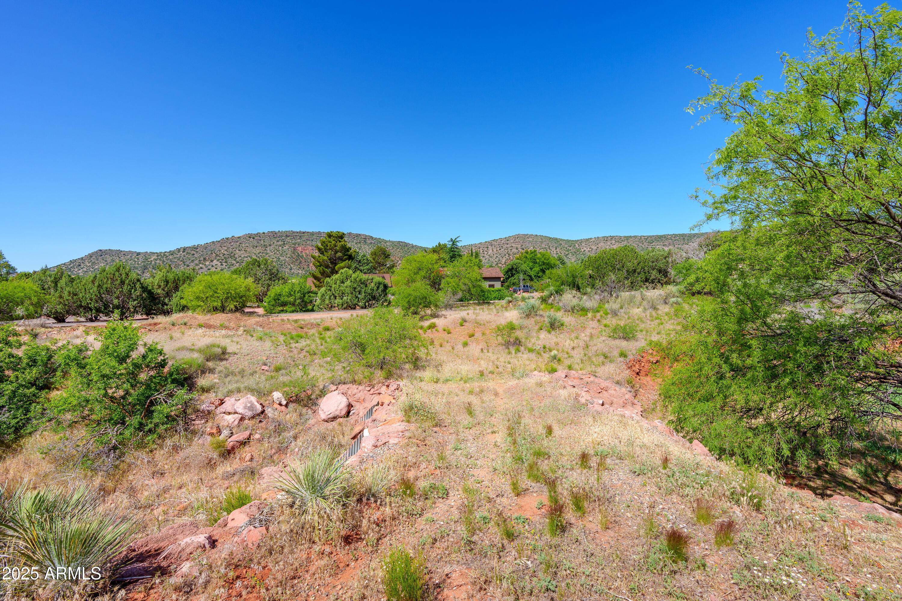 105 East Saddlehorn Road, Unit 161 Sedona, AZ 86351 - Photo 25 of 33 a view of a lake with mountains in the background